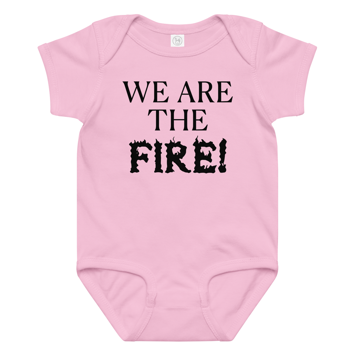 "We are the fire!" printed on a pink baby jersey bodysuit laying on a flat surface amongst other clothes