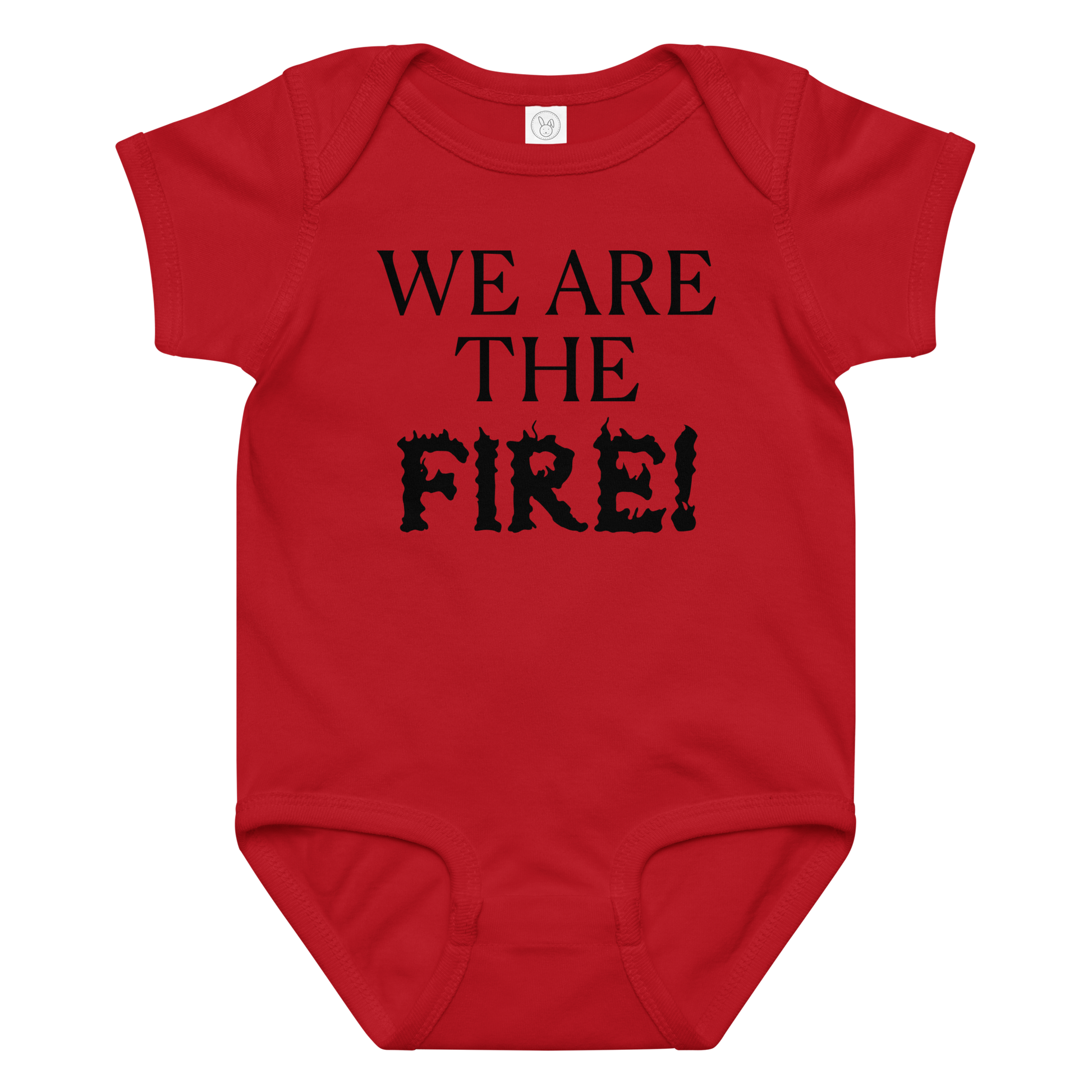 "We are the fire!" printed on a red baby jersey bodysuit laying on a flat surface amongst other clothes