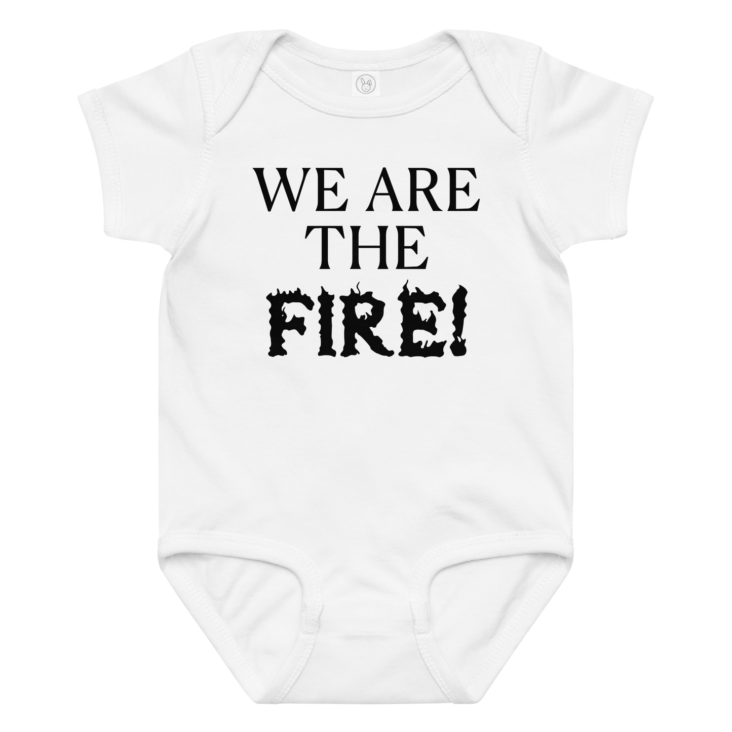 "We are the fire!" printed on a white baby jersey bodysuit laying on a flat surface amongst other clothes
