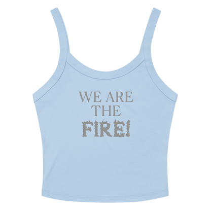 "We are the fire!" printed on a solid baby blue blend women's micro-rib tanktop laying on a flat surface amongst sunglasses and shorts