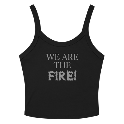 "We are the fire!" printed on a solid black blend women's micro-rib tanktop laying on a flat surface amongst sunglasses and shorts