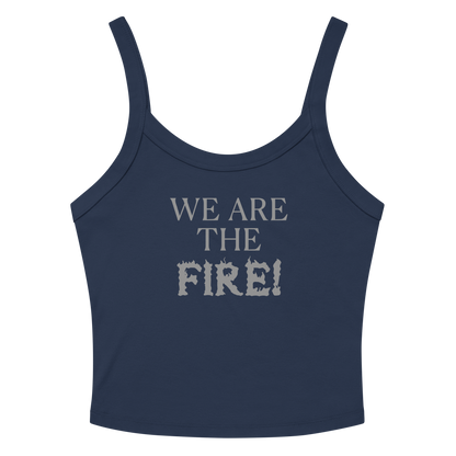 "We are the fire!" printed on a solid navy blend women's micro-rib tanktop laying on a flat surface amongst sunglasses and shorts