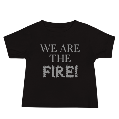 "We are the fire!" printed on a black baby jersey short sleeve tee laying on a flat surface