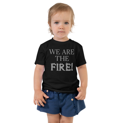 "We are the fire!" printed on a black toddler short sleeve tee worn by a female
