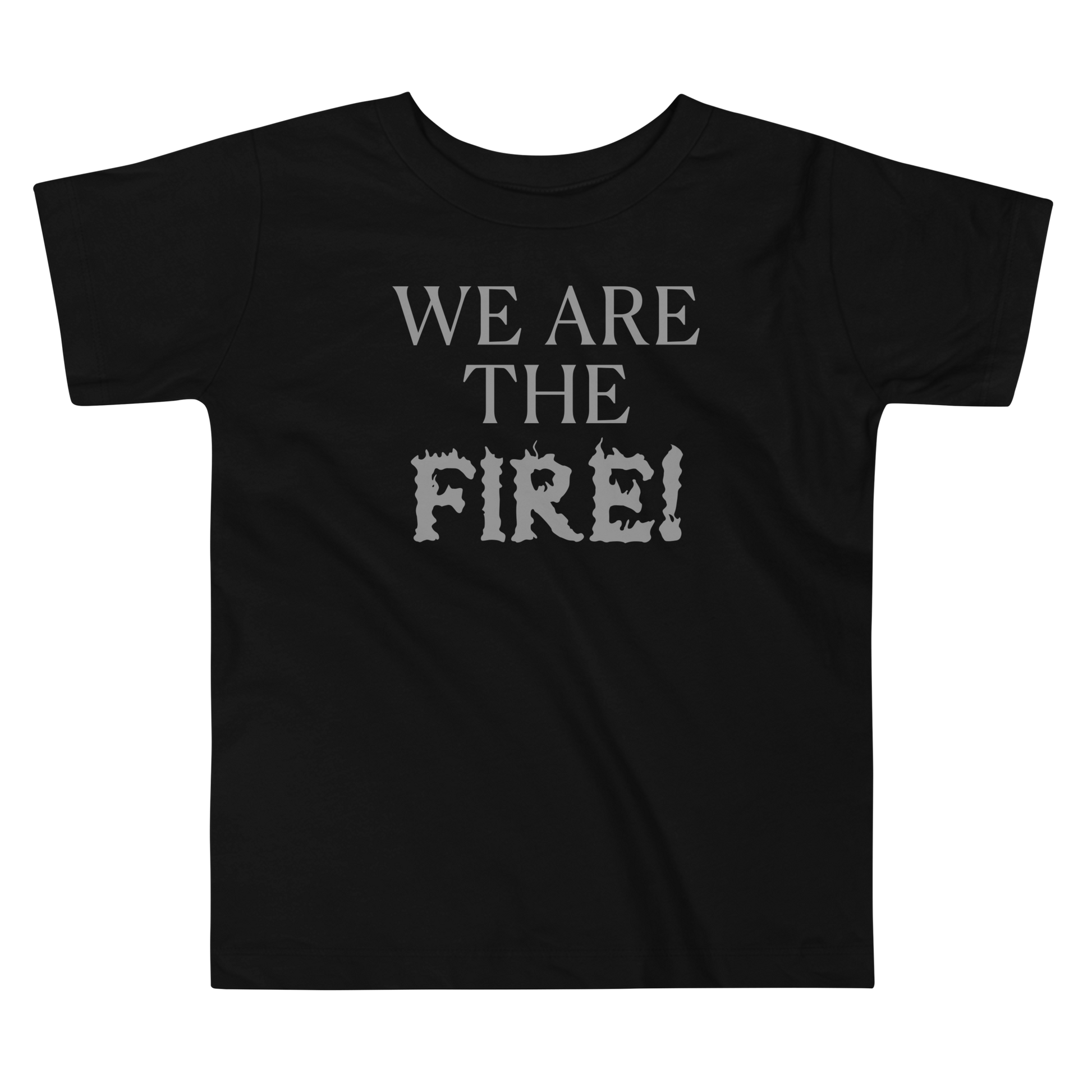 "We are the fire!" printed on a black toddler short sleeve tee laying on a flat surface