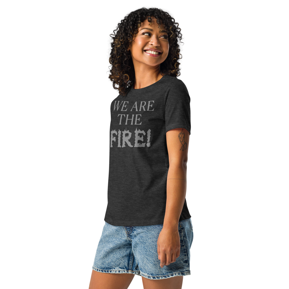 "We are the fire!" printed on a dark grey heather women's relaxed t-shirt worn by a female