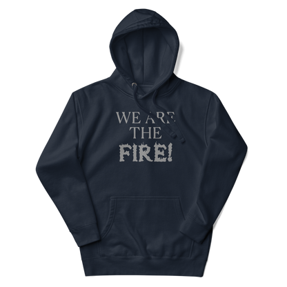 "We are the fire!" printed on a navy blazer unisex hoodie laying on a flat surface with the hood up