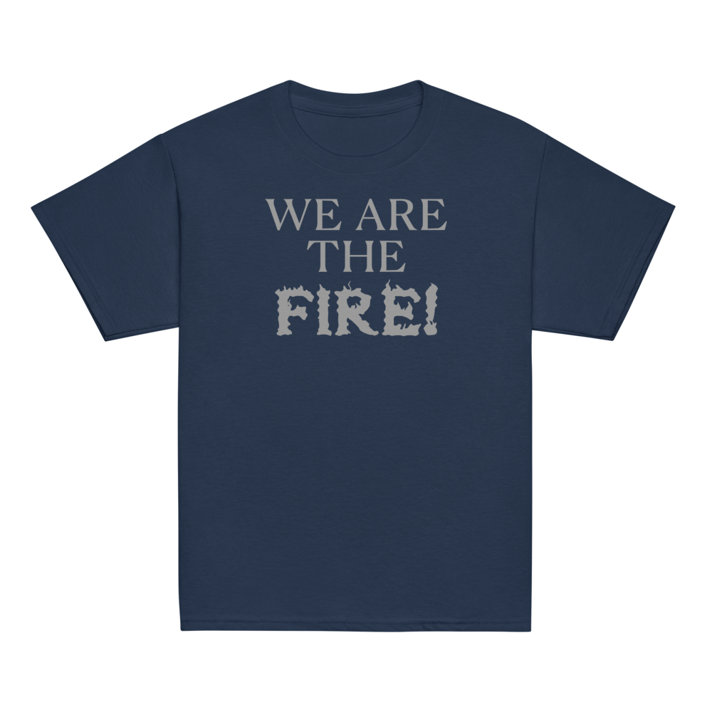 "We are the fire!" printed on a navy youth classic tee laying on a flat surface