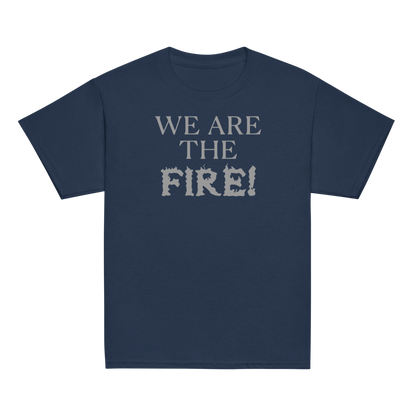 "We are the fire!" printed on a navy youth classic tee laying on a flat surface