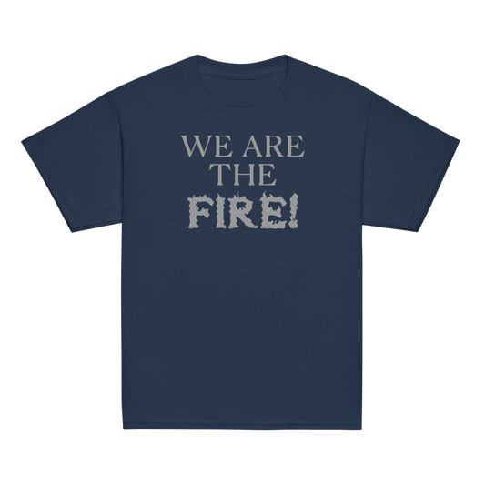 "We are the fire!" printed on a navy youth classic tee laying on a flat surface