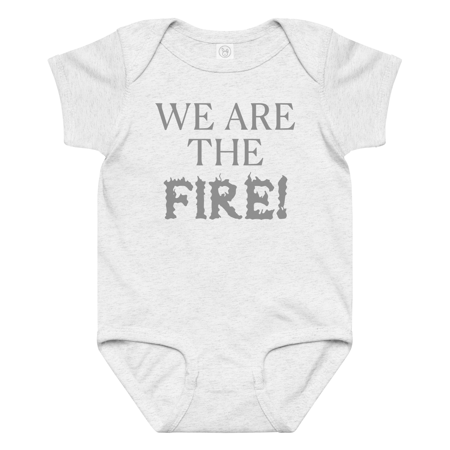 "We are the fire!" printed on a ash baby jersey bodysuit laying on a flat surface amongst other clothes