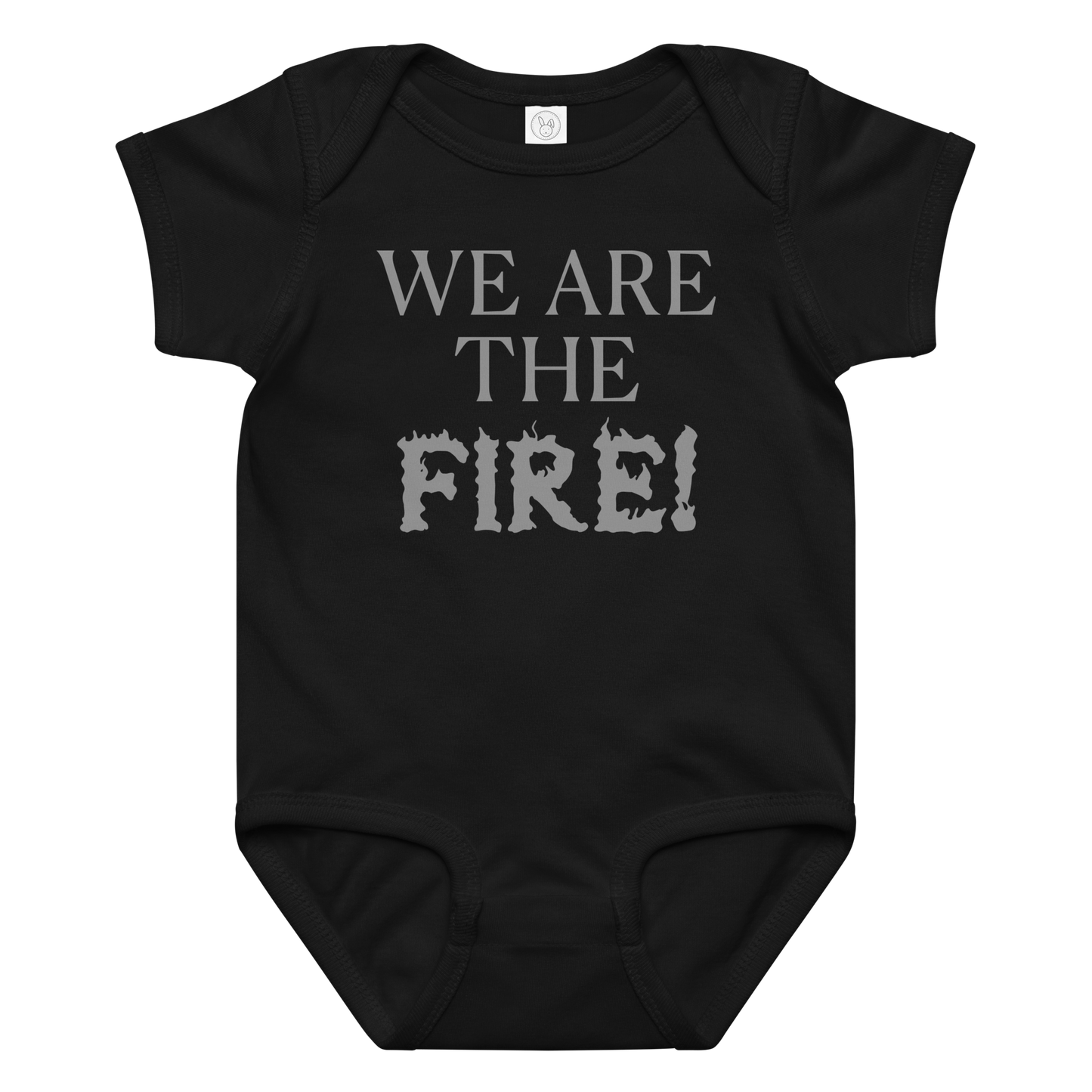 "We are the fire!" printed on a black baby jersey bodysuit laying on a flat surface amongst other clothes