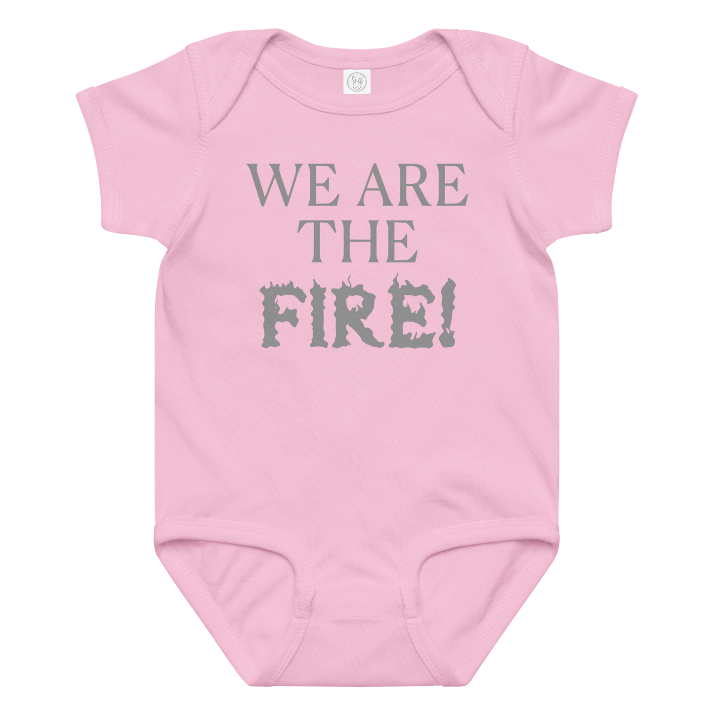 "We are the fire!" printed on a pink baby jersey bodysuit laying on a flat surface amongst other clothes