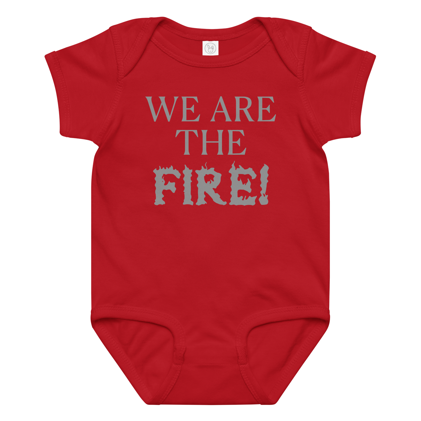 "We are the fire!" printed on a red baby jersey bodysuit laying on a flat surface amongst other clothes