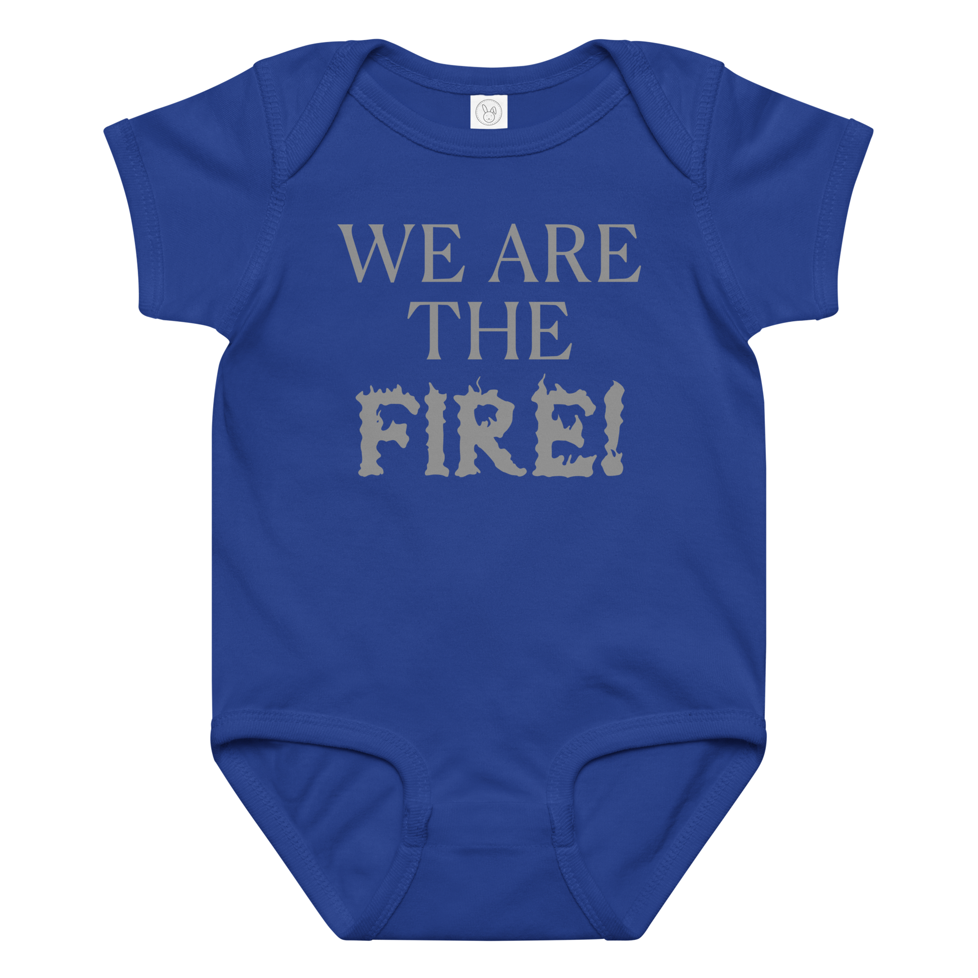 "We are the fire!" printed on a royal baby jersey bodysuit laying on a flat surface amongst other clothes