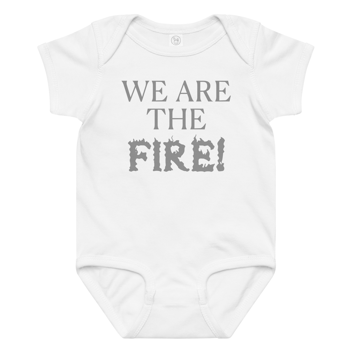 "We are the fire!" printed on a white baby jersey bodysuit laying on a flat surface amongst other clothes