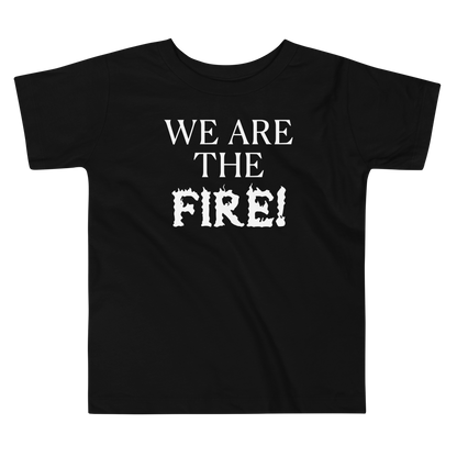 "We are the fire!" printed on a black toddler short sleeve tee laying on a flat surface