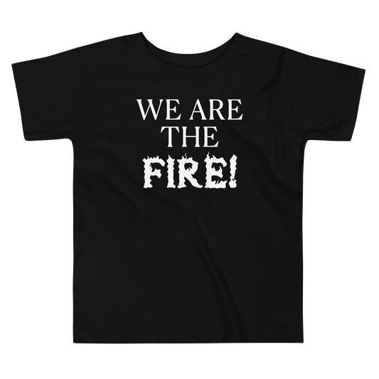 "We are the fire!" printed on a black toddler short sleeve tee laying on a flat surface