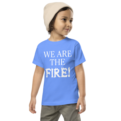 "We are the fire!" printed on a heather columbia blue toddler short sleeve tee worn by a male wearing a cap