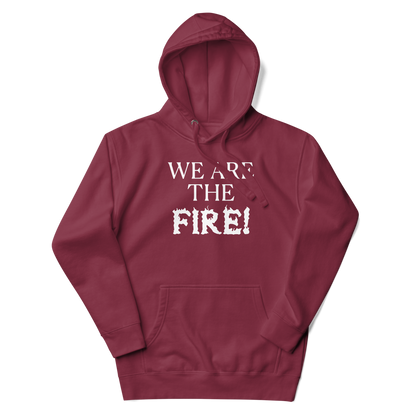 "We are the fire!" printed on a maroon unisex hoodie laying on a flat surface with the hood up