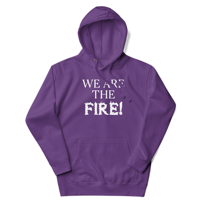 "We are the fire!" printed on a purple unisex hoodie laying on a flat surface with the hood up