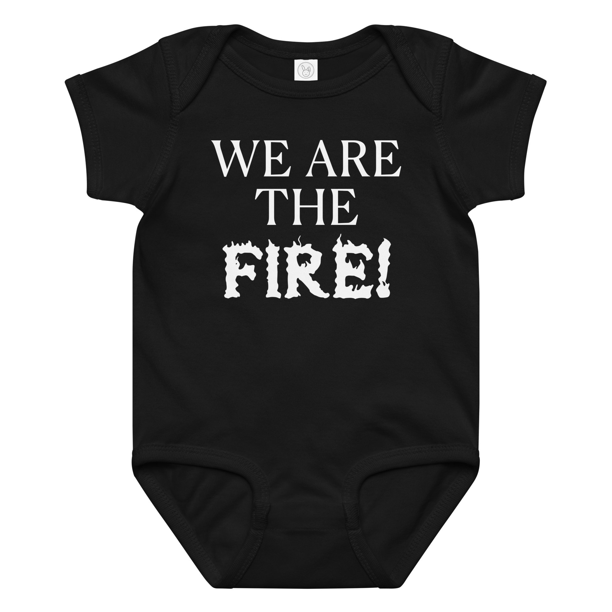 "We are the fire!" printed on a black baby jersey bodysuit laying on a flat surface amongst other clothes