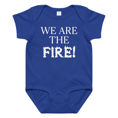 "We are the fire!" printed on a royal baby jersey bodysuit laying on a flat surface amongst other clothes