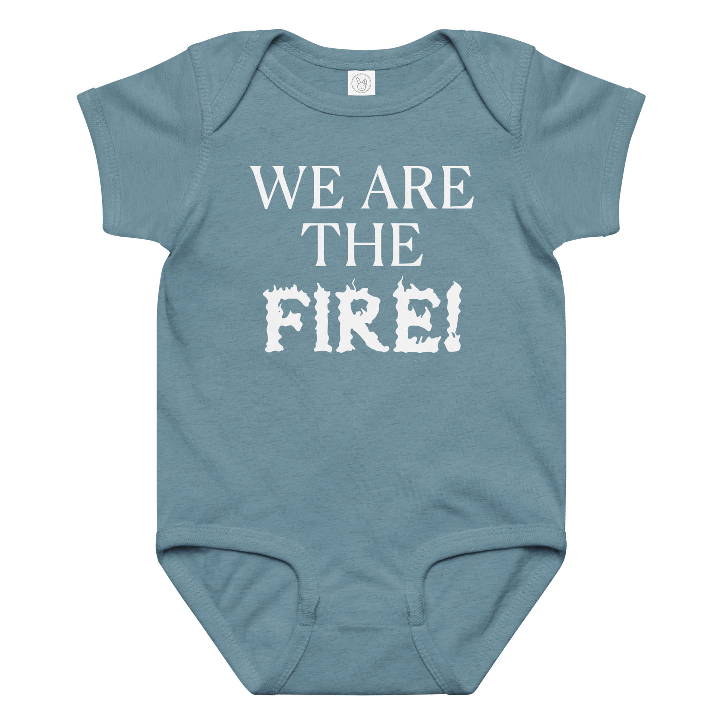 "We are the fire!" printed on a vintage indigo baby jersey bodysuit laying on a flat surface amongst other clothes