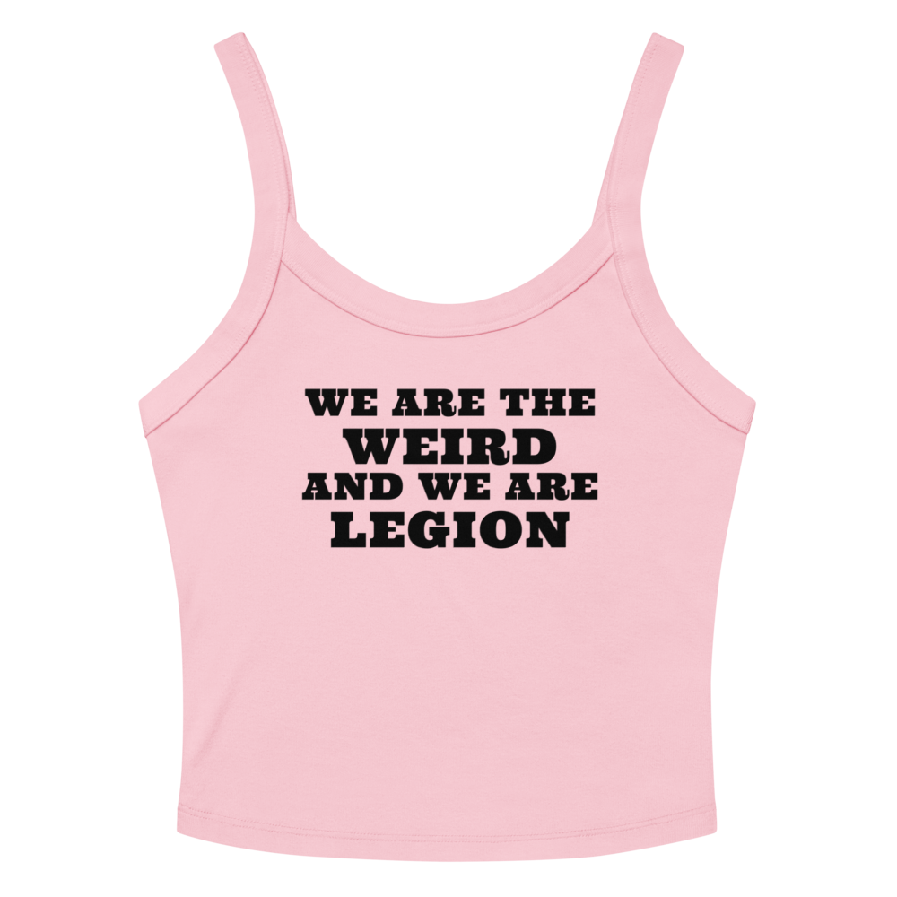"We are the weird and we are legion" printed on a solid pink blend women's micro-rib tanktop laying on a flat surface amongst sunglasses and shorts