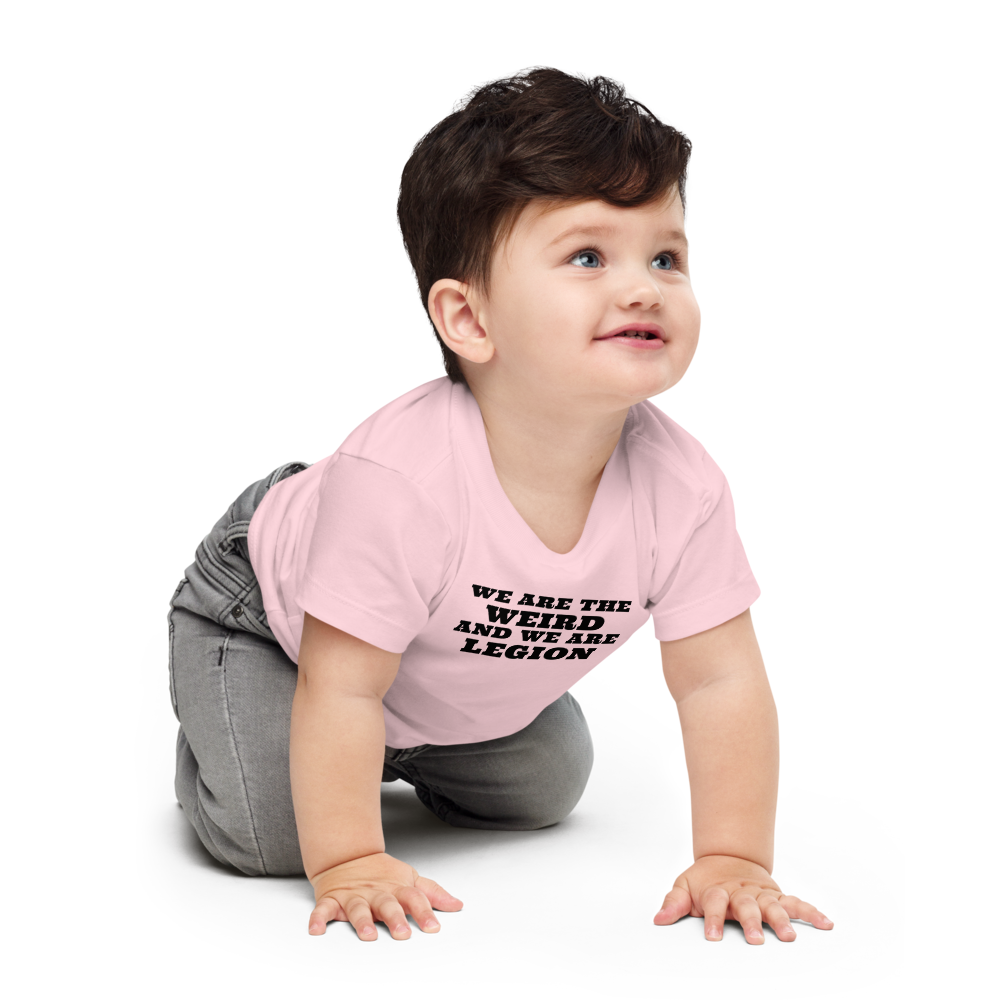 "We are the weird and we are legion" printed on a pink baby jersey short sleeve tee worn by a male who is crawling