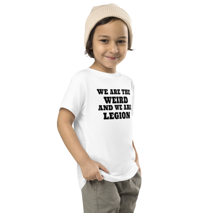 "We are the weird and we are legion" printed on a white toddler short sleeve tee worn by a male who is also wearing a knit cap