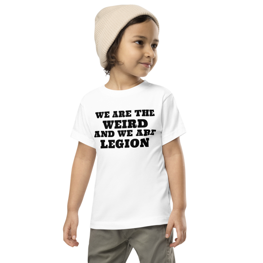 "We are the weird and we are legion" printed on a white toddler short sleeve tee worn by a male wearing a cap