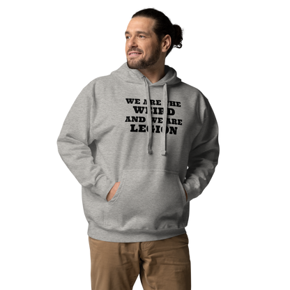 "We are the weird and we are legion" printed on a carbon grey unisex hoodie worn by a male
