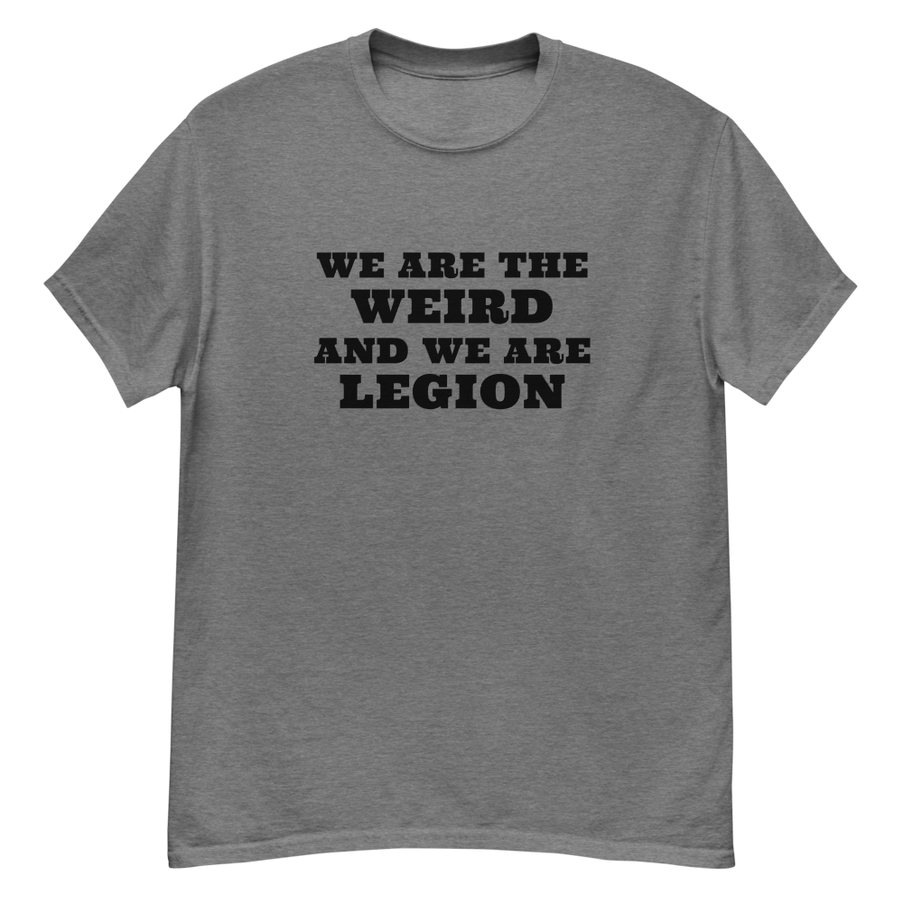 "We are the weird and we are legion" printed on a graphite heather unisex classic tee laying on a flat surface
