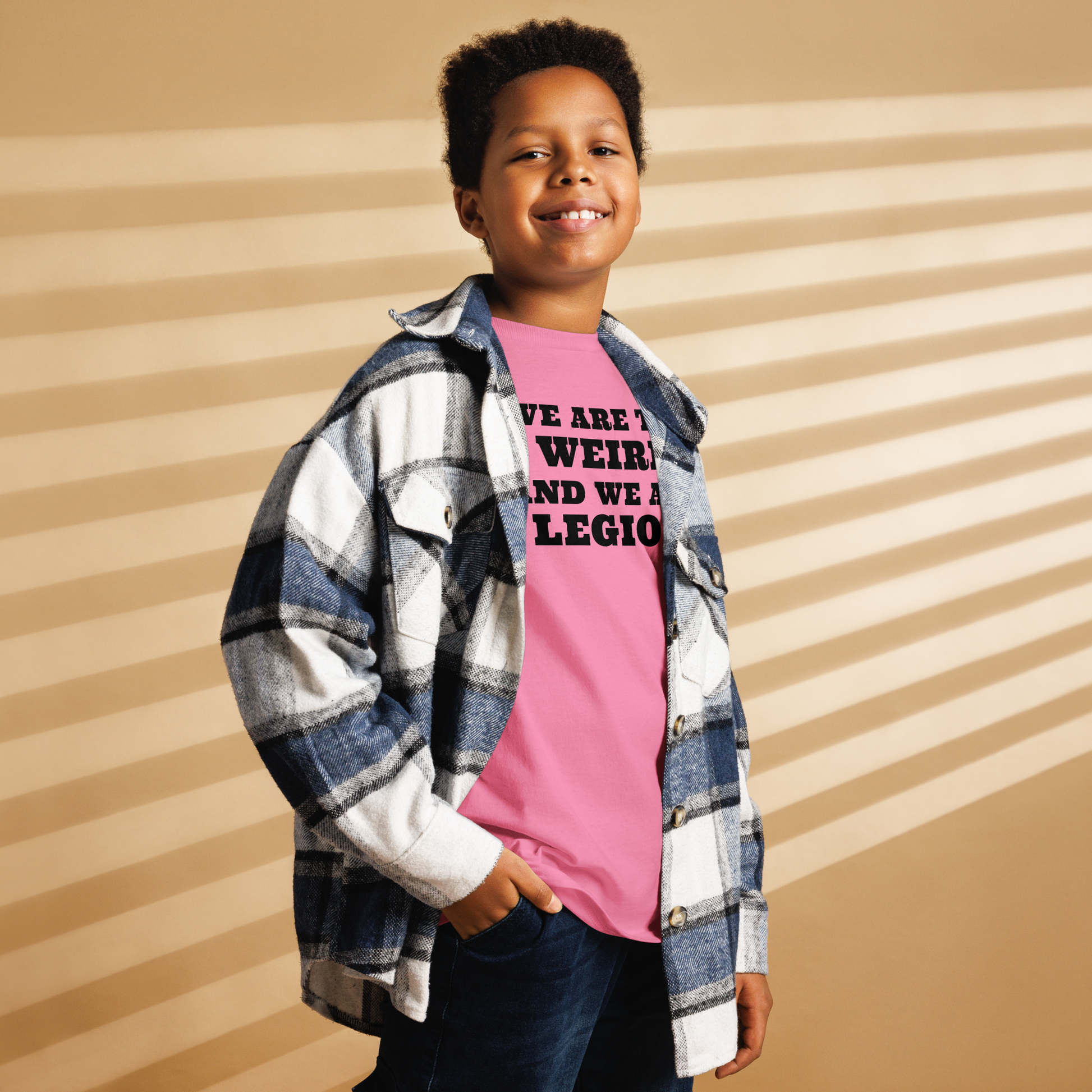 "We are the weird and we are legion" printed on a azalea youth classic tee worn by a male also wearing a jacket