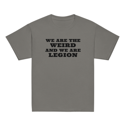 "We are the weird and we are legion" printed on a charcoal youth classic tee laying on a flat surface