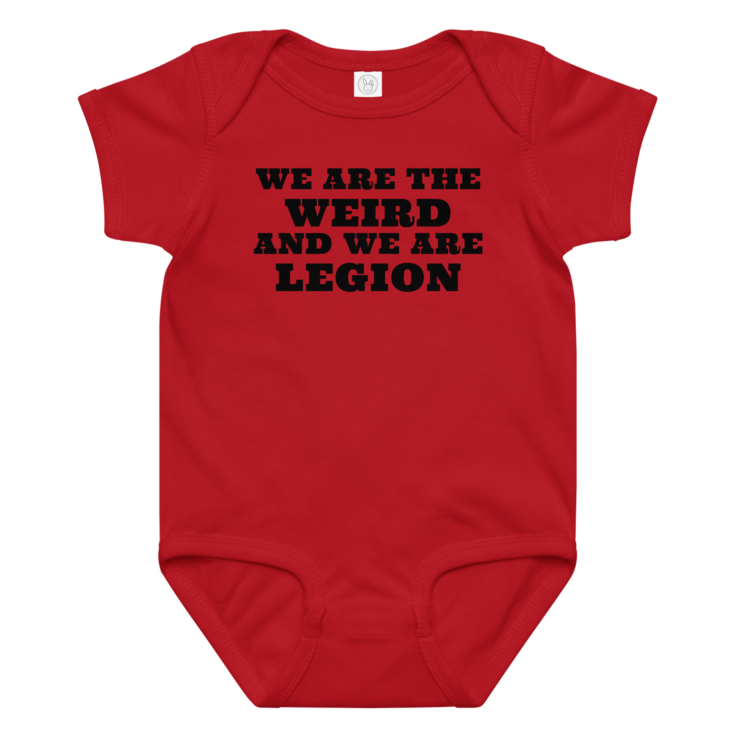 "We are the weird and we are legion" printed on a red baby jersey bodysuit laying on a flat surface amongst other clothes