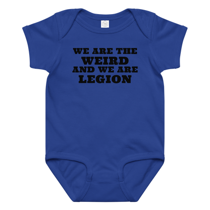 "We are the weird and we are legion" printed on a royal baby jersey bodysuit laying on a flat surface amongst other clothes