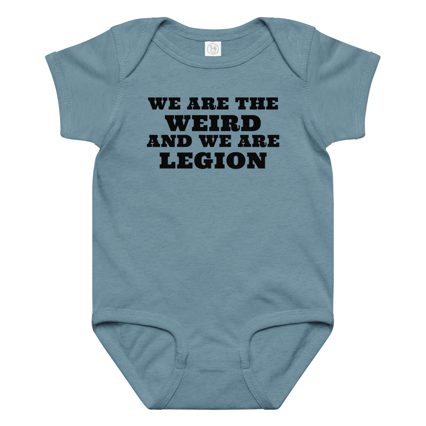 "We are the weird and we are legion" printed on a vintage indigo baby jersey bodysuit laying on a flat surface amongst other clothes