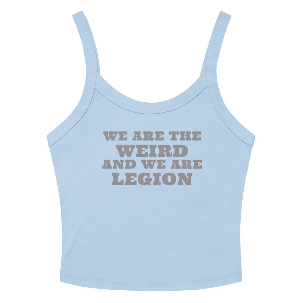 "We are the weird and we are legion" printed on a solid baby blue blend women's micro-rib tanktop laying on a flat surface amongst sunglasses and shorts