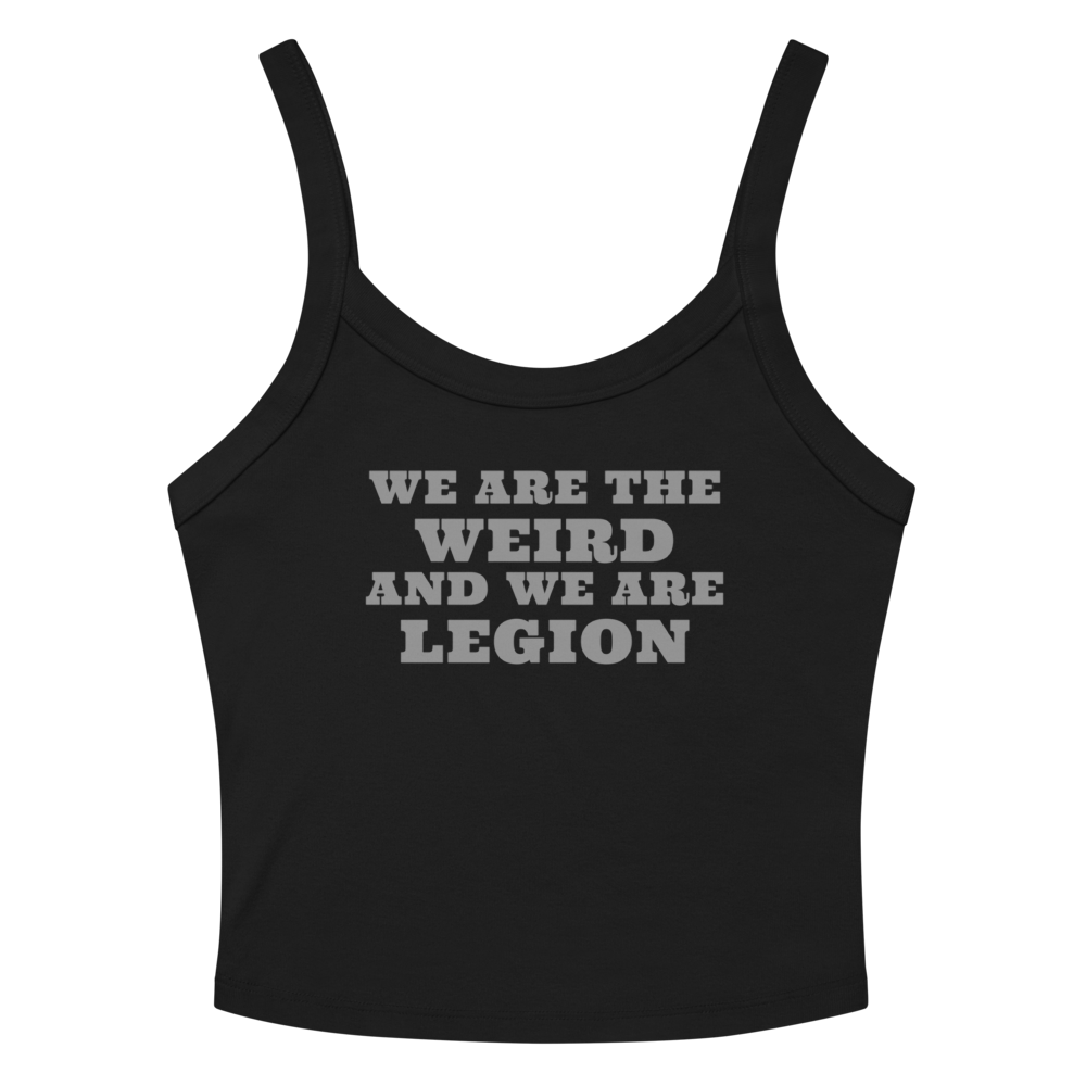 "We are the weird and we are legion" printed on a solid black blend women's micro-rib tanktop laying on a flat surface amongst sunglasses and shorts