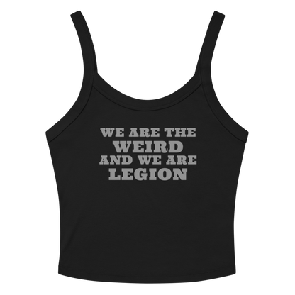 "We are the weird and we are legion" printed on a solid black blend women's micro-rib tanktop laying on a flat surface amongst sunglasses and shorts