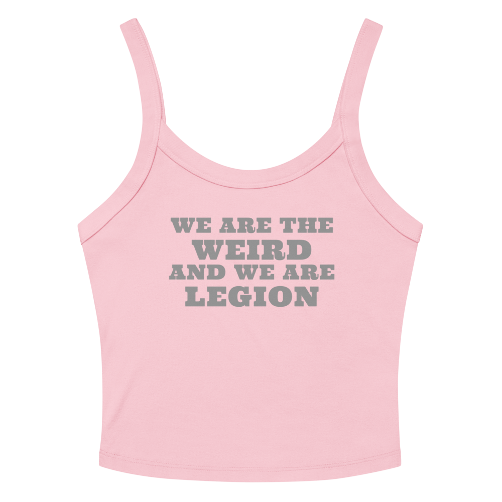 "We are the weird and we are legion" printed on a solid pink blend women's micro-rib tanktop laying on a flat surface amongst sunglasses and shorts
