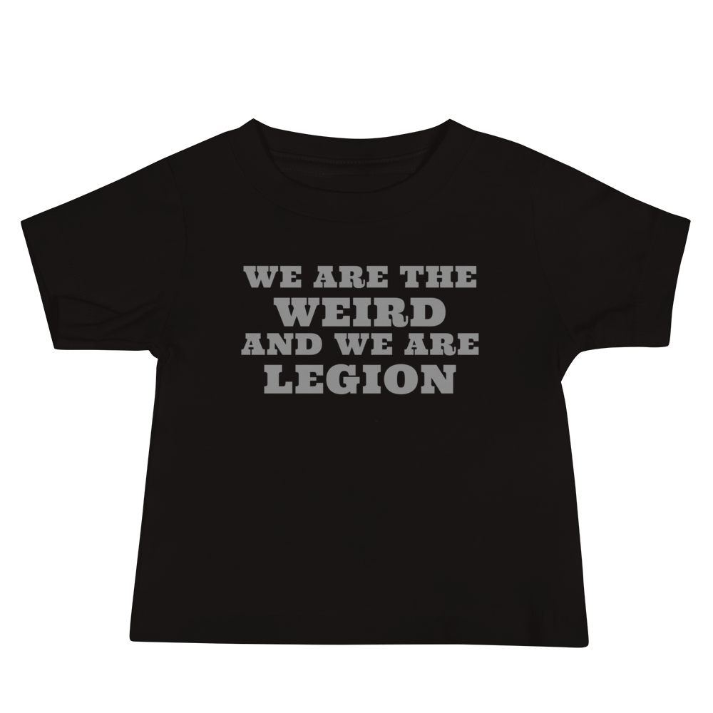 "We are the weird and we are legion" printed on a black baby jersey short sleeve tee laying on a flat surface