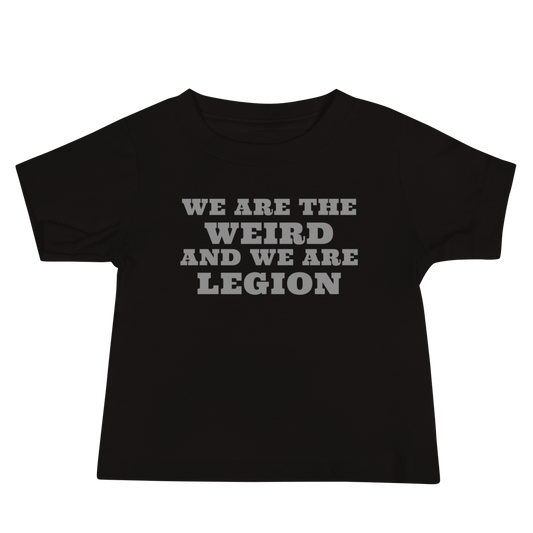"We are the weird and we are legion" printed on a black baby jersey short sleeve tee laying on a flat surface