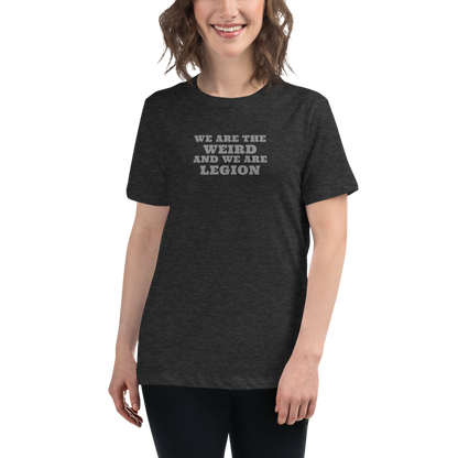 "We are the weird and we are legion" printed on a dark grey heather women's relaxed t-shirt worn by a female