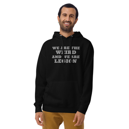 "We are the weird and we are legion" printed on a black warn by a male