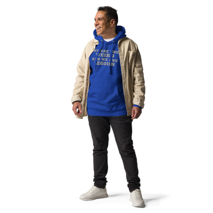 "We are the weird and we are legion" printed on a team royal unisex hoodie worn by a male with a jacket on top