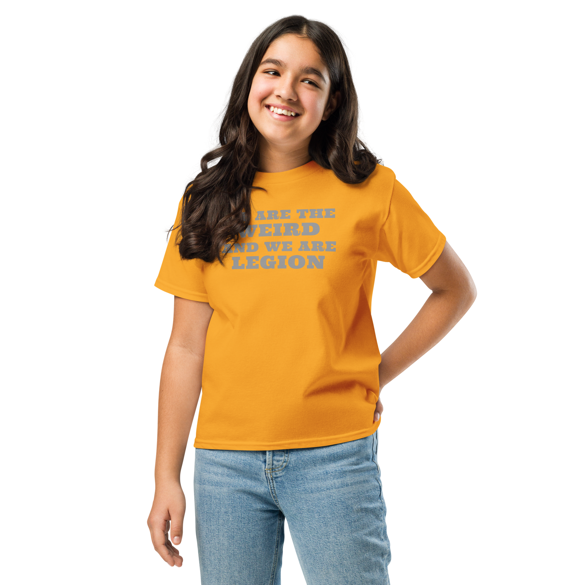 "We are the weird and we are legion" printed on a gold youth classic tee worn by a female