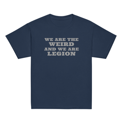 "We are the weird and we are legion" printed on a navy youth classic tee laying on a flat surface